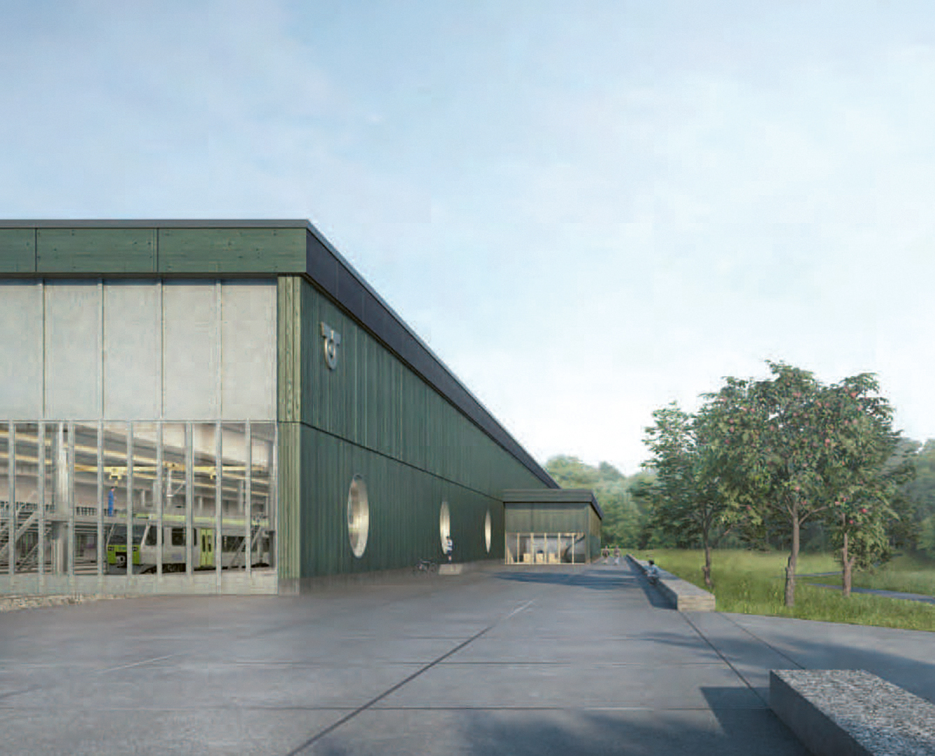 Die ARGE pool Architekten / b+p baurealisation hat ihr Projekt an der Ostfassade mit grossen Glasflächen transparent gestaltet. Die Aussenfassade ist mit Holz in einem dunklen Grünton beplankt.