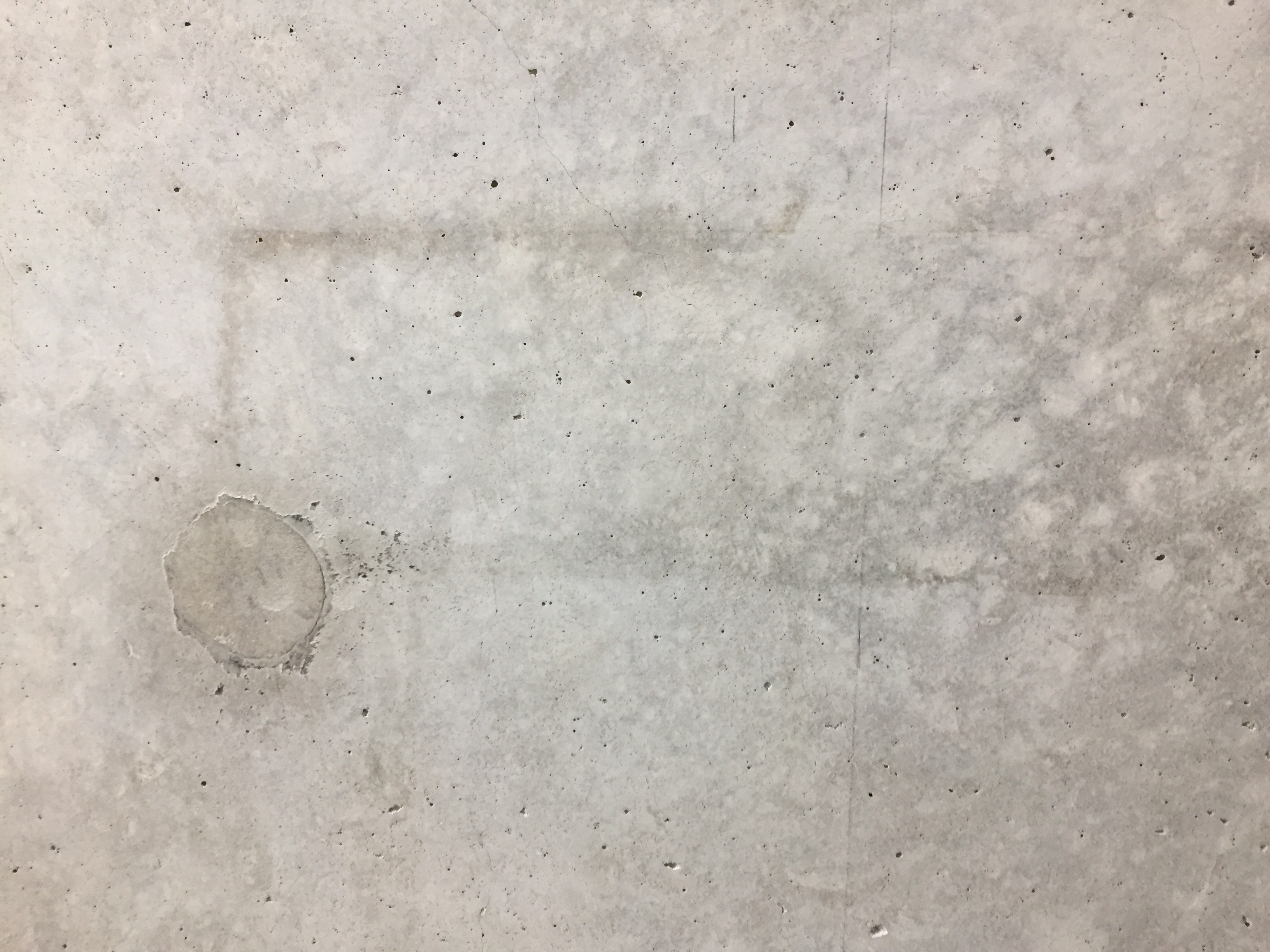 Bohrlöcher werden von einem Restaurator mit dem exakt gleichen Beton, aus dem auch die Wand besteht, wieder verschlossen. Die Spuren der Ausstellungen fügen sich zu einem eigenen Bild.