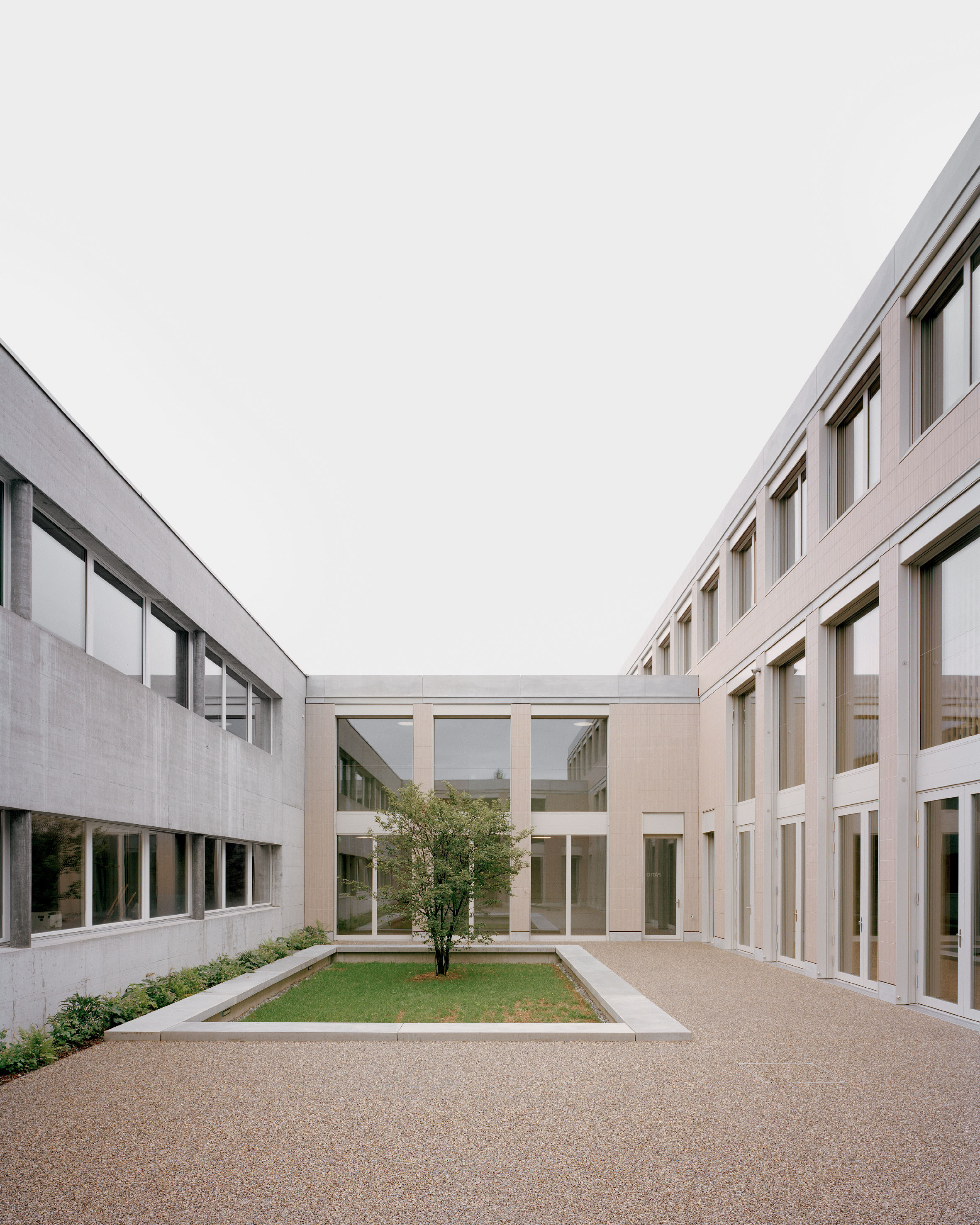 Le nouveau patio tient lieu d’espace extérieur introverti et  de passage à l’air libre entre l’aile ancienne réservée aux salles de classe et la construction neuve.