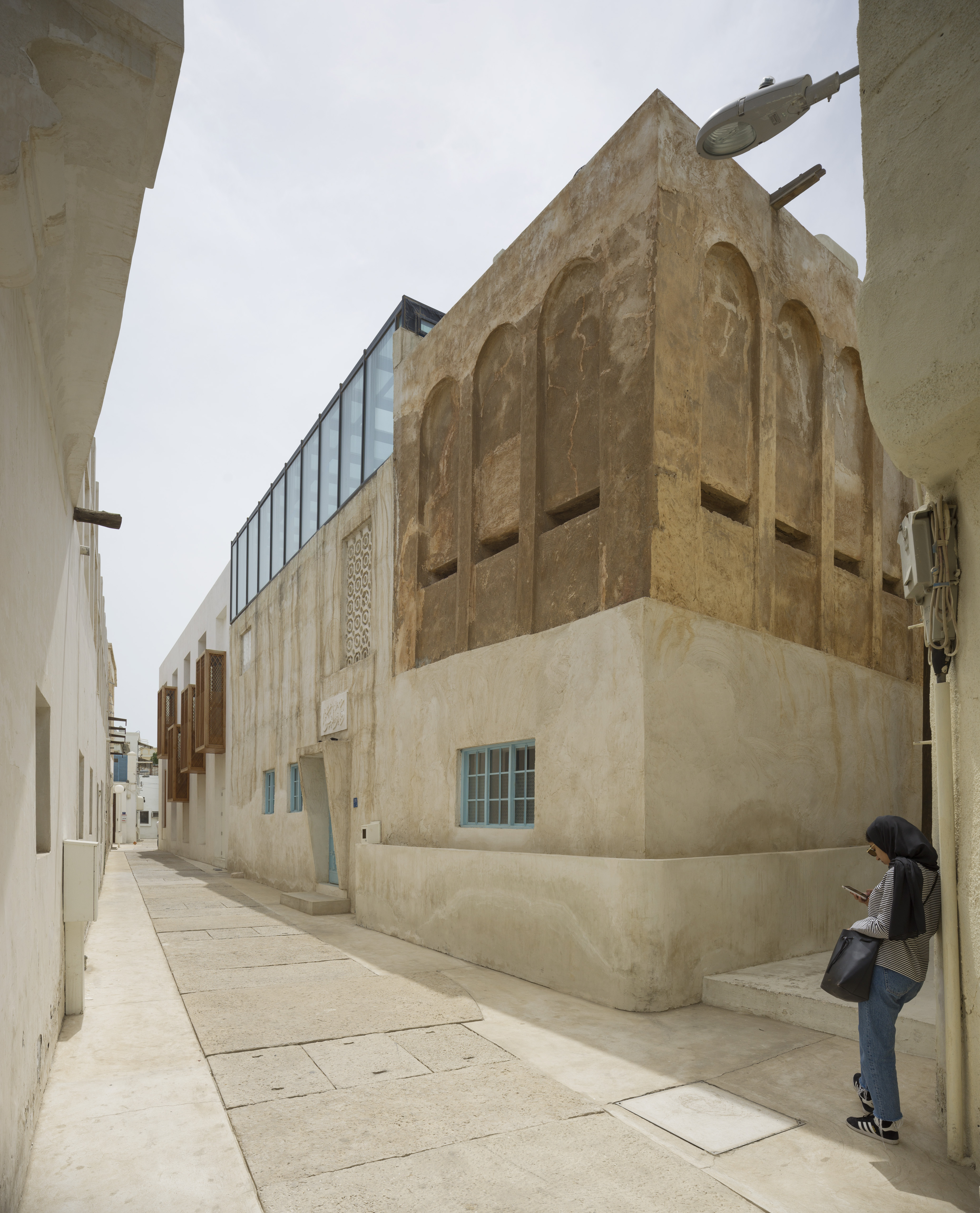 Exterior of a 19th century wall integrated to the courtyard of a 1940s building.