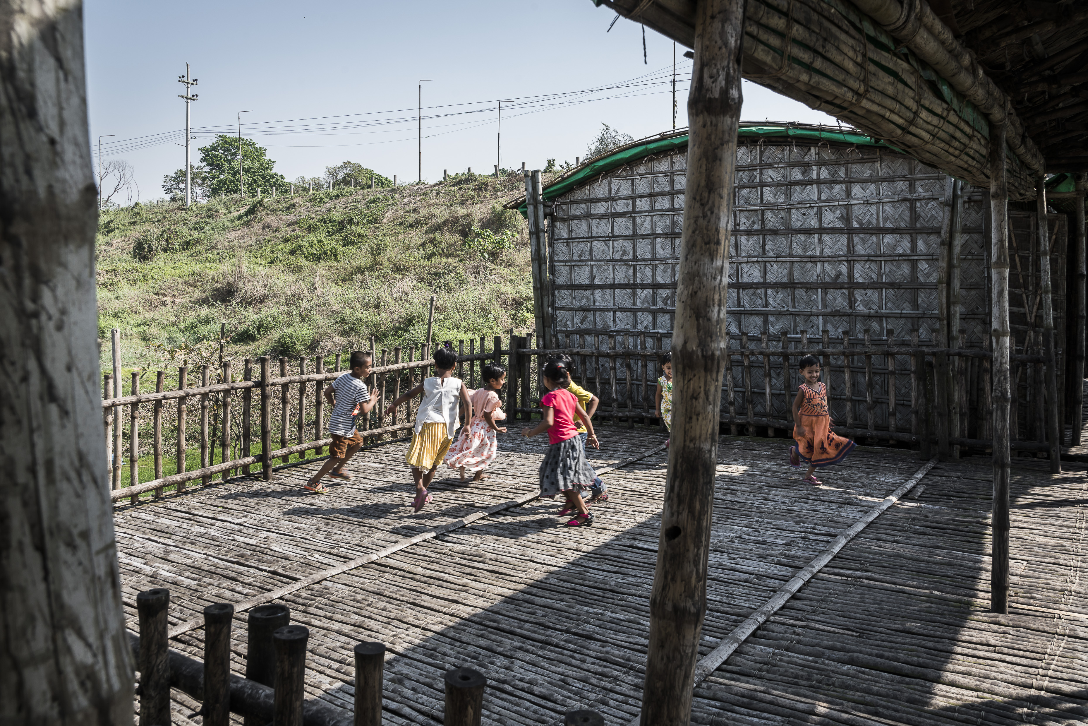 Children playing in the courtyard. They can run and bounce a little on the flexible bamboo floor.