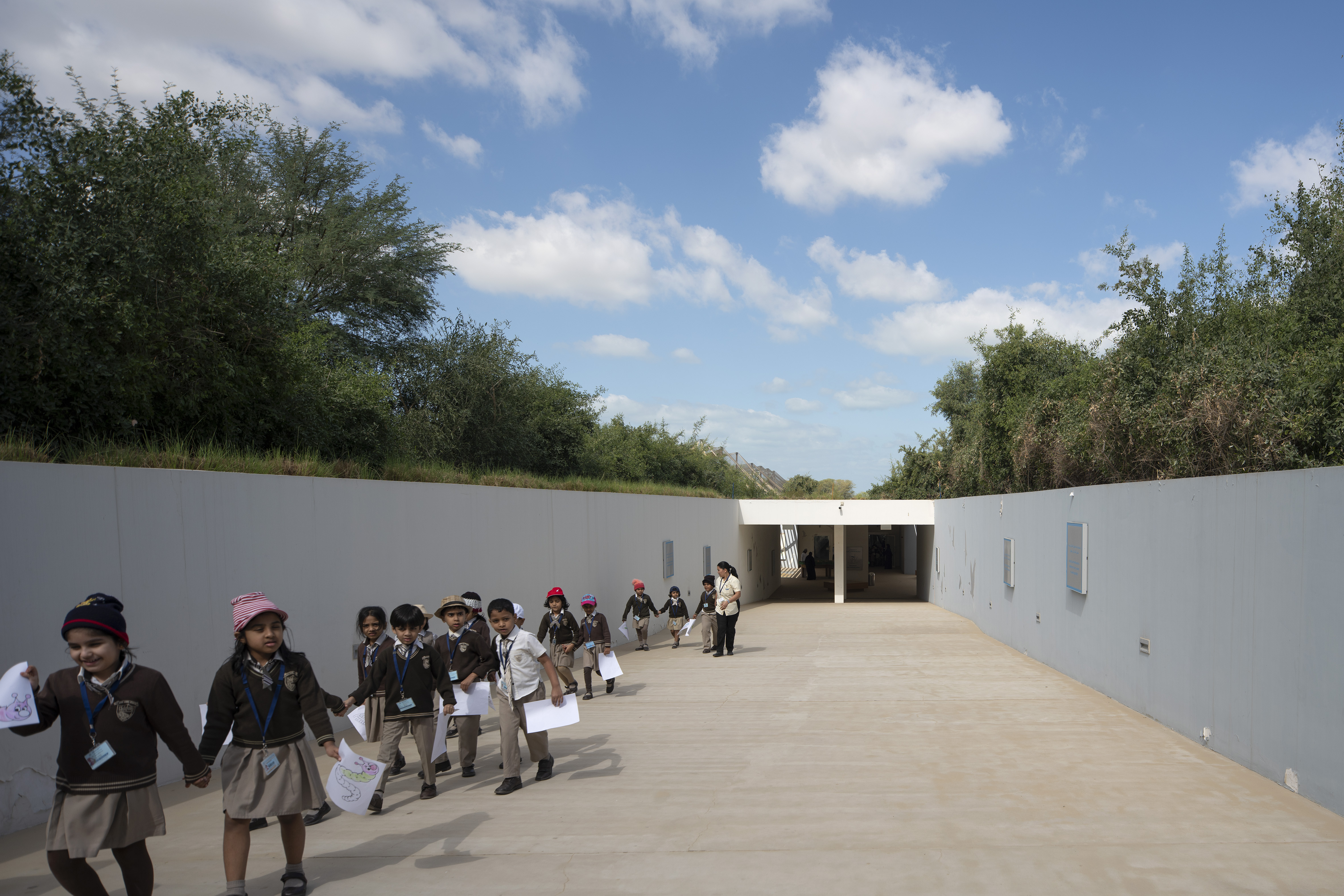 Most of the building is buried beneath ground level, leaving the landscape unspoiled. A sloping ramp gives access to its entrance.