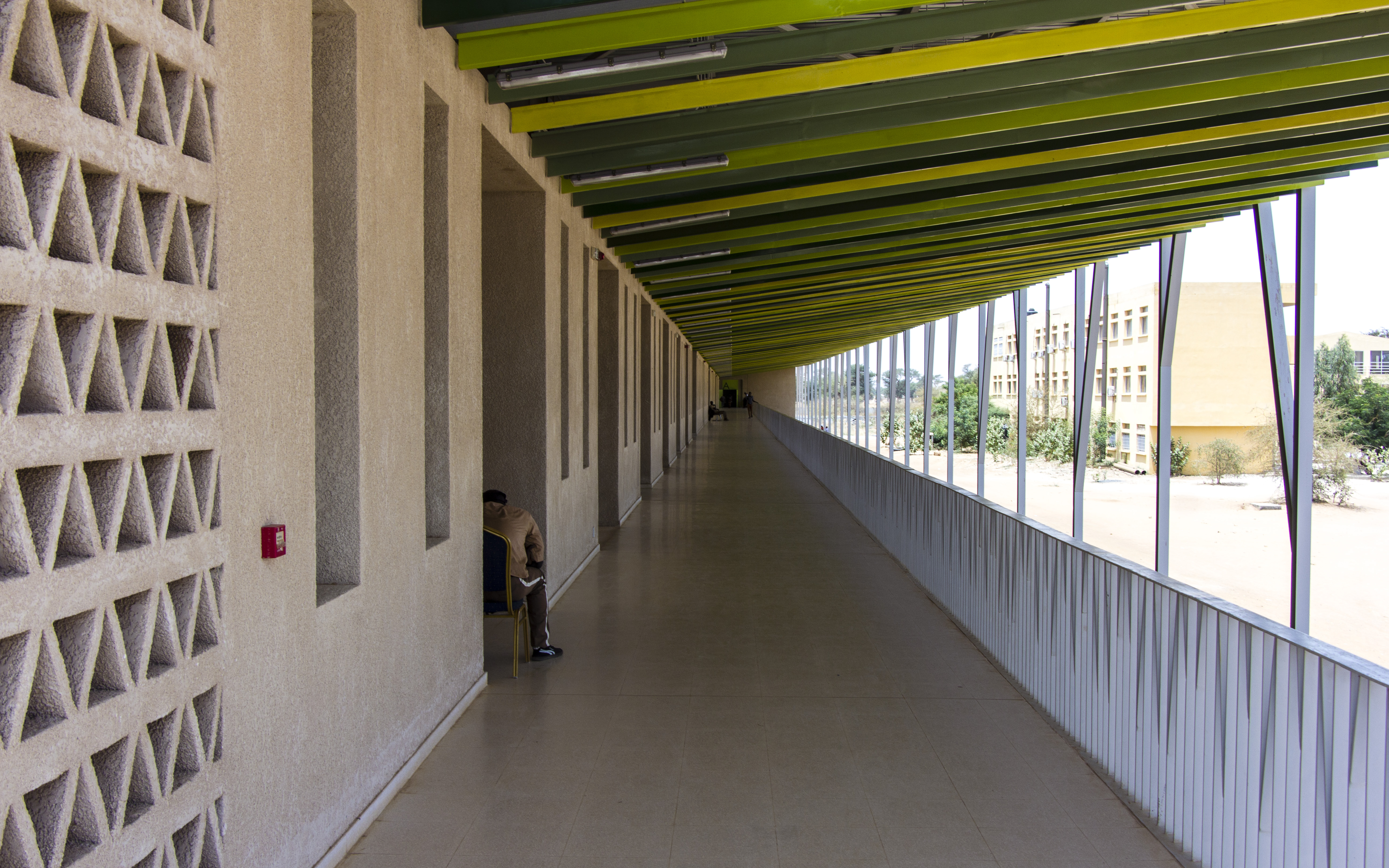 Exterior corridor shaded by the double roof.