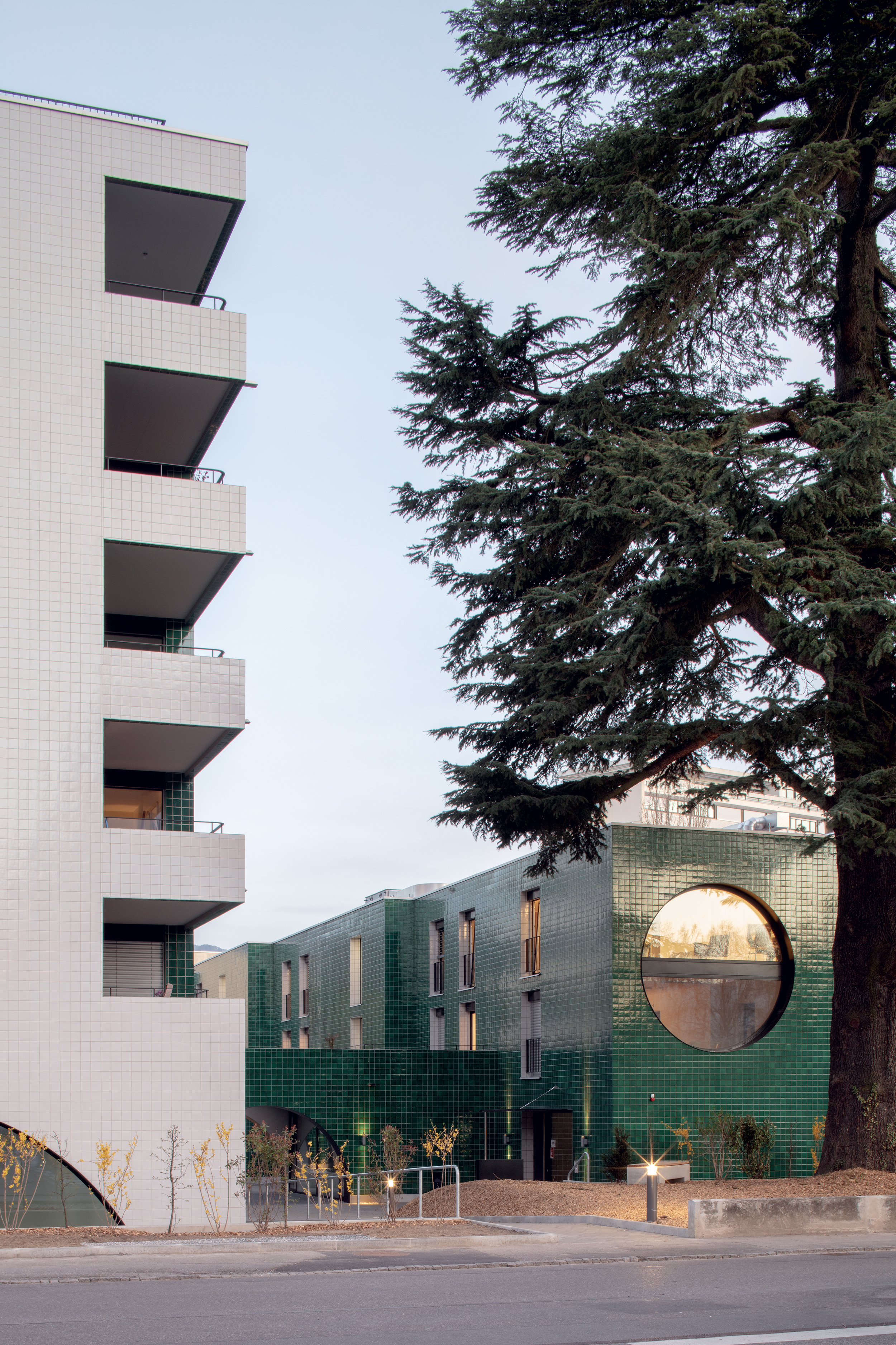 Vue des deux volumes depuis le chemin des Pâquerettes, à Lancy. Le plus haut des deux abrite des logements sociaux, alors que celui couleur jade accueille des logements étudiants ainsi que des habitations de la fondation Sgipa pour personnes présentant une forme de déficience intellectuelle.