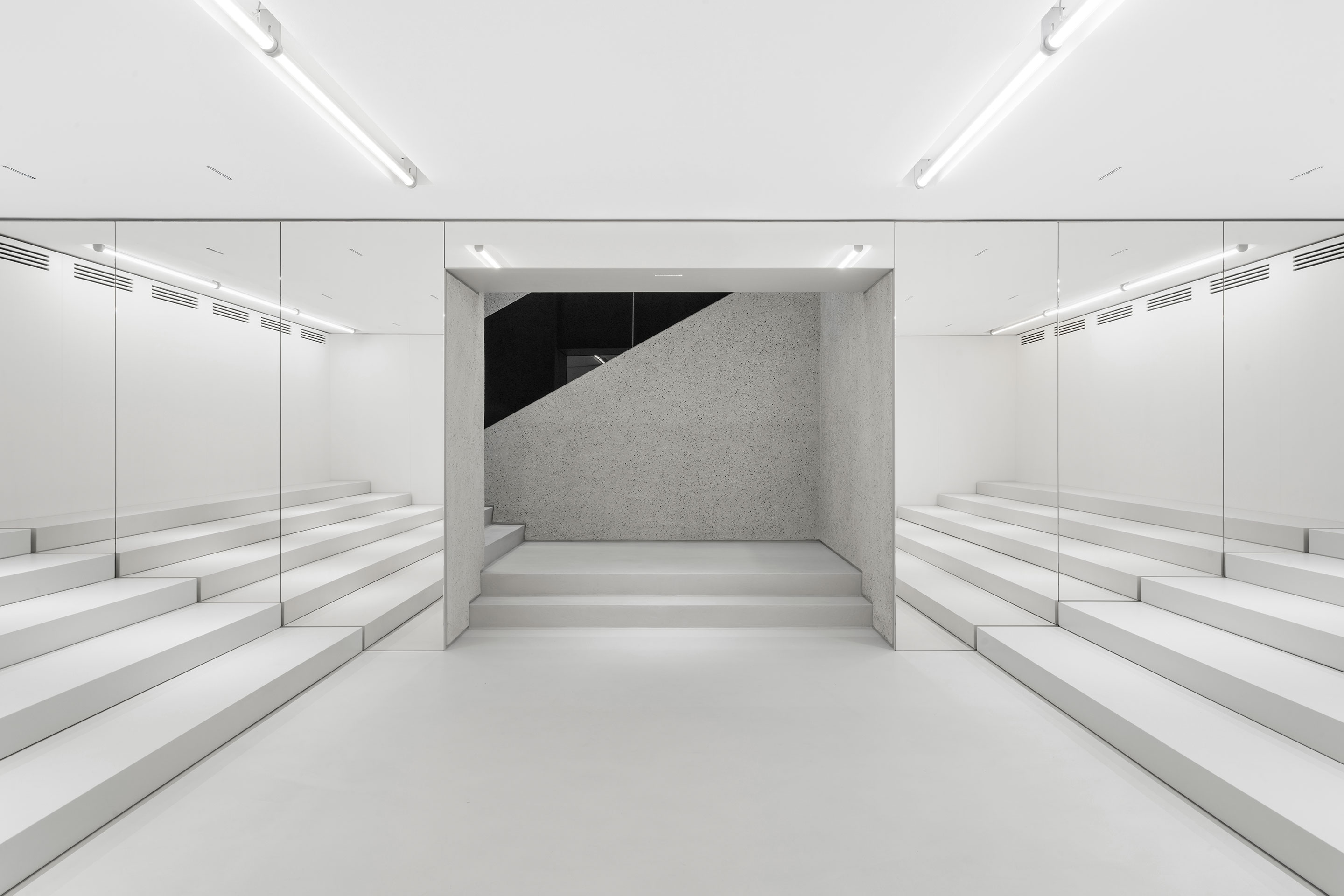 Im Untergeschoss füllen zwei weisse, sich gegenüberstehende Stufenelemente den Raum aus. Sie können als Auditorium oder als Ausstellungsfläche verwendet werden.