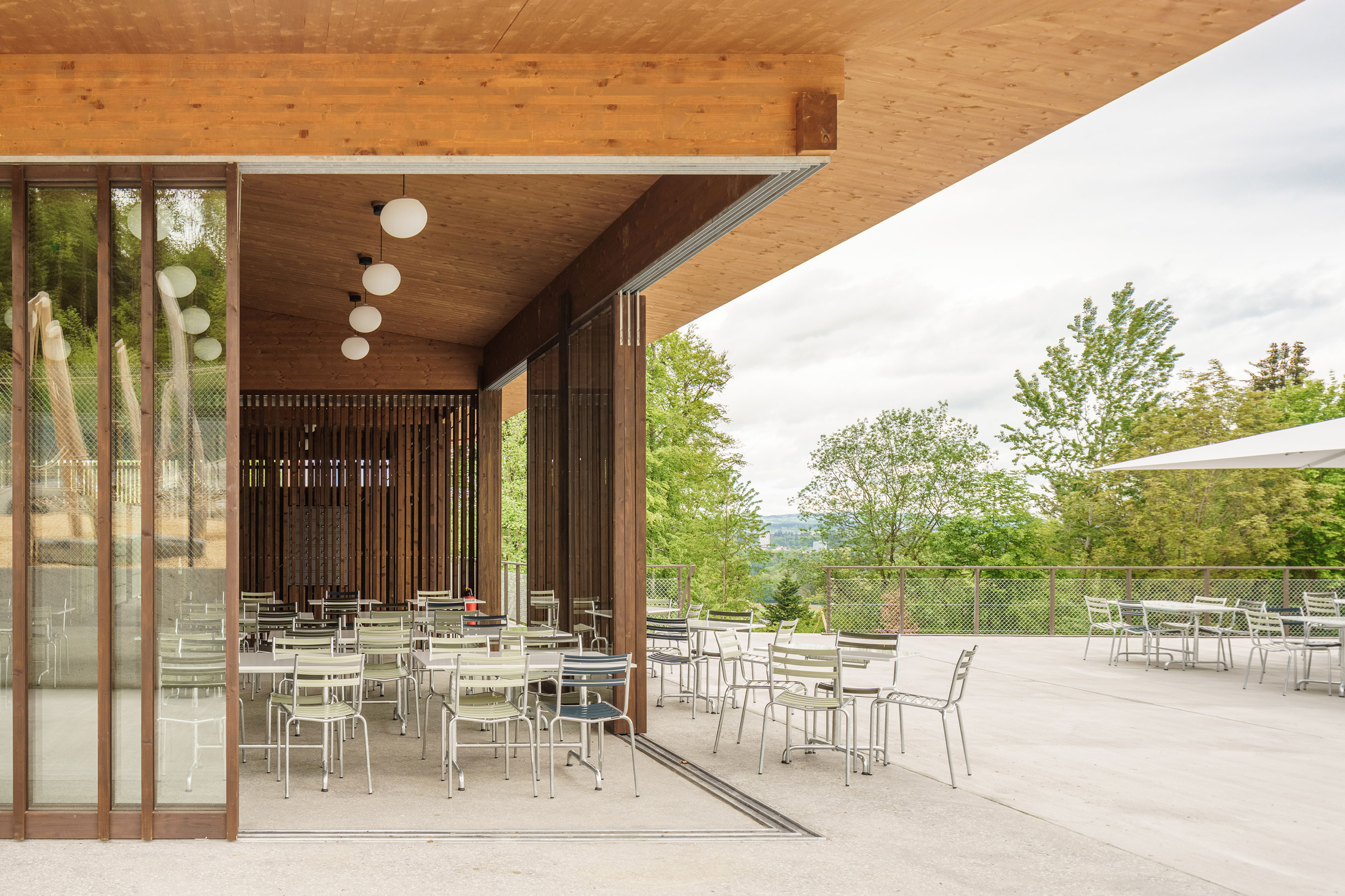 Die raumhoch verglasten Schiebetüren im Restaurant lassen sich öffnen und transformieren den Innenraum zur gedeckten Terrasse.