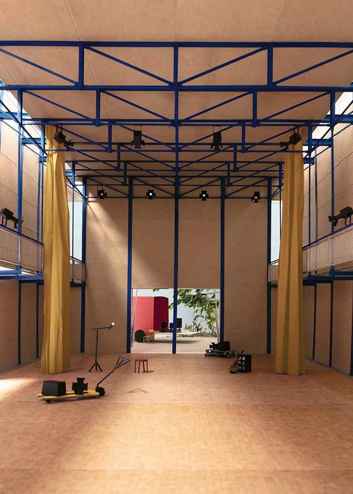 Made with reused steel elements and rammed earth walls, the new multipurpose hall exudes a restrained atmosphere reminiscent of the theatrical world.