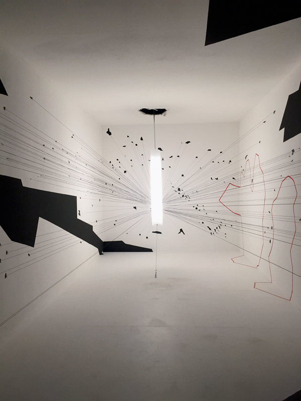 Eyal Weizmann beschäftigt sich mit Architektur-Forensik: Die Installation zeigt die Stelle, an der eine Drohne durch das Dach eines Gebäudes einschlug, und die durch Gebäudesplitter verursachten Einschlagstellen an den Wänden. Vor den rot umrahmten Feldern, wo es keine Einschlagstellen hat, befanden sich Menschen.