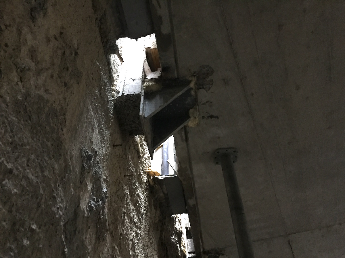 Anschlussdetail zwischen der Geschossdecke im 2. UG und der Schlitzwand zum Bahndamm: Schwarze Gummieinlagen verhindern, dass sich die Erschütterungen des Bahnverkehrs auf das Hochhaus übertragen.