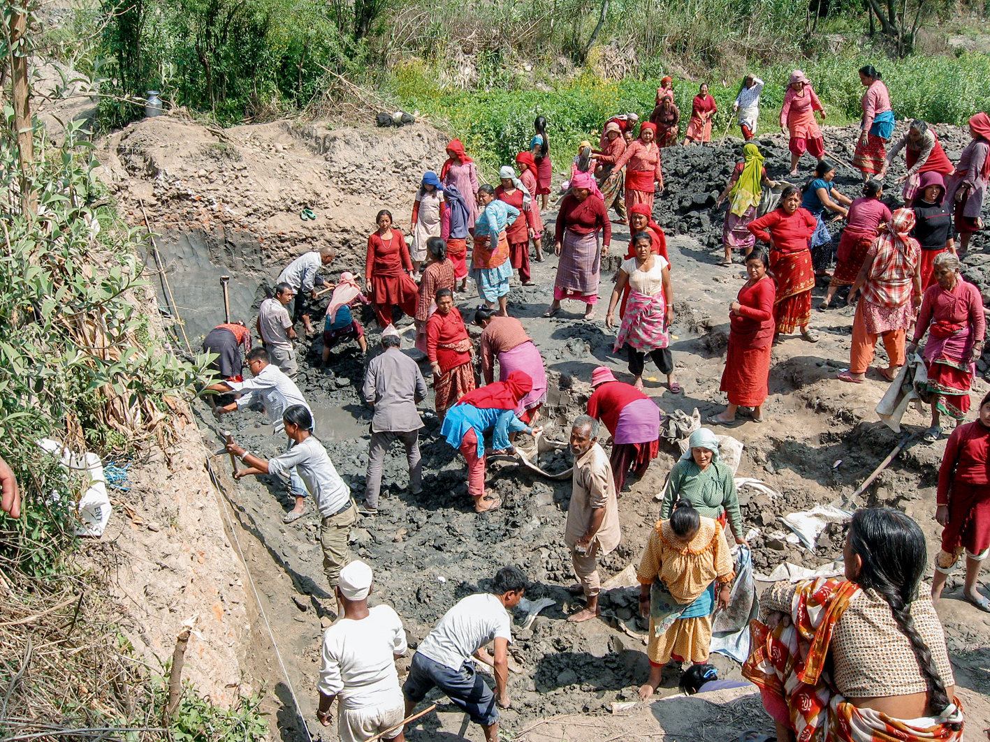 Frauen aus Nala helfen mit beim Bau der Anlage, indem sie die Baustelle vorbereiten. Gräser und Pflanzen werden entfernt. (Bild: Eawag/Sandec)