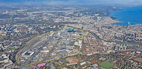 Luftbild mit Perimeter Praille - Acacias - Vernets, rechts davon die Altstadt von Carouge, links die Gemeinde Lancy, dahinter die Innenstadt von Genf
