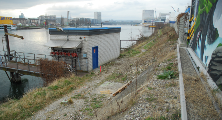 Damit Fussgänger und Velofahrer in Zukunft entlang des Rheins von Basel nach Huningue (und umgekehrt) gelangen können, ist auf Höhe des BASF-Geländes eine Stegkonstruktion parallel zum Wasser notwendig.