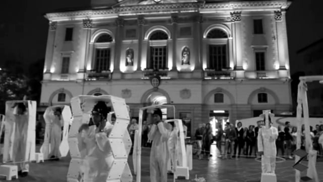 Preview image for the video "Mise-en-scène N02 - Architetti in rivoluzione. Luogo: Piazza Riforma Lugano. Data: 2011-12, Semestre Primaverile. Concept: Atelier Orizzontale Blumer. Riprese: Iara De Carvalho" - Thumbnail.